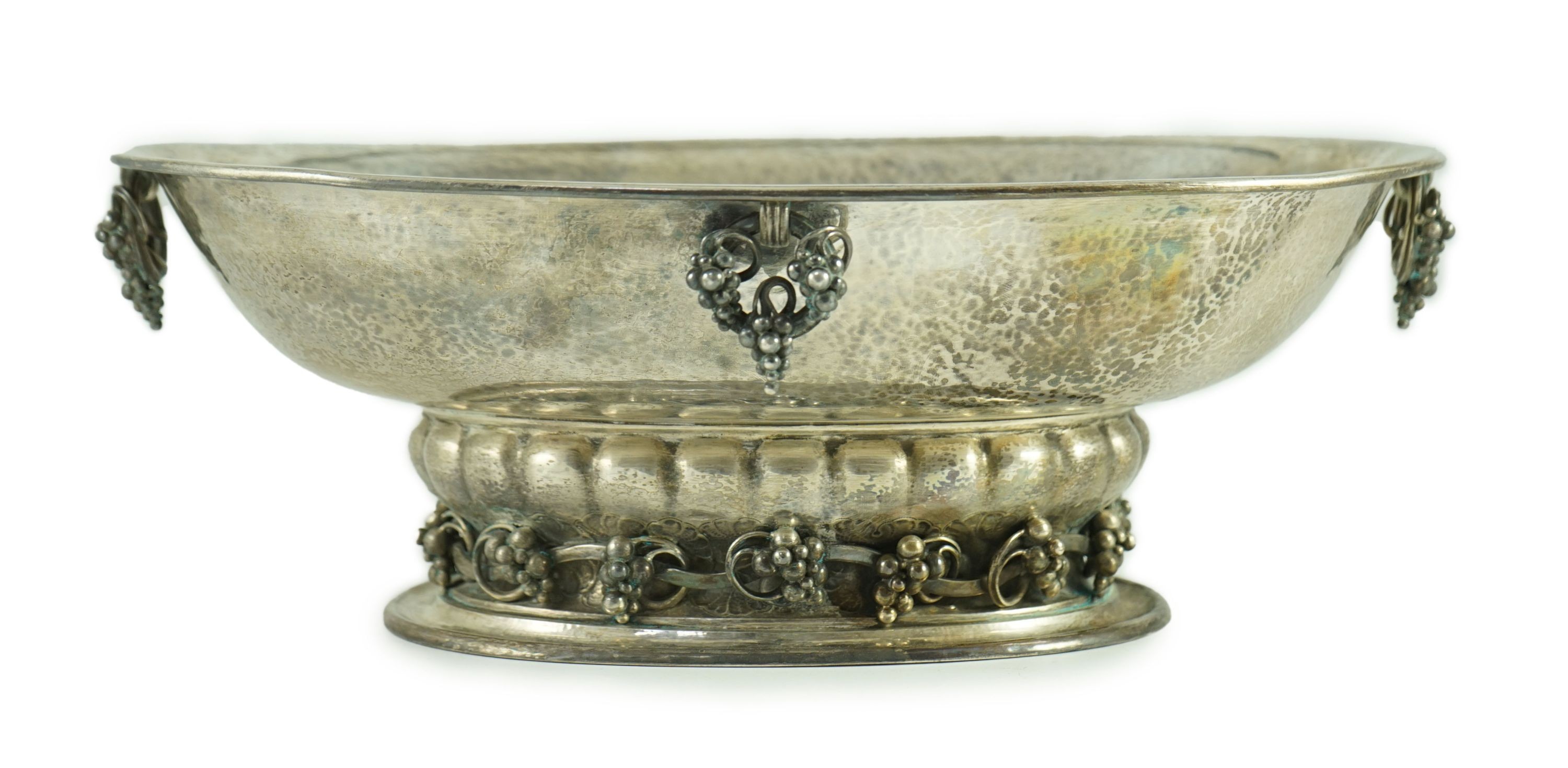 A good George V Georg Jensen planished silver Grape pattern oval pedestal fruit bowl, design no. 296